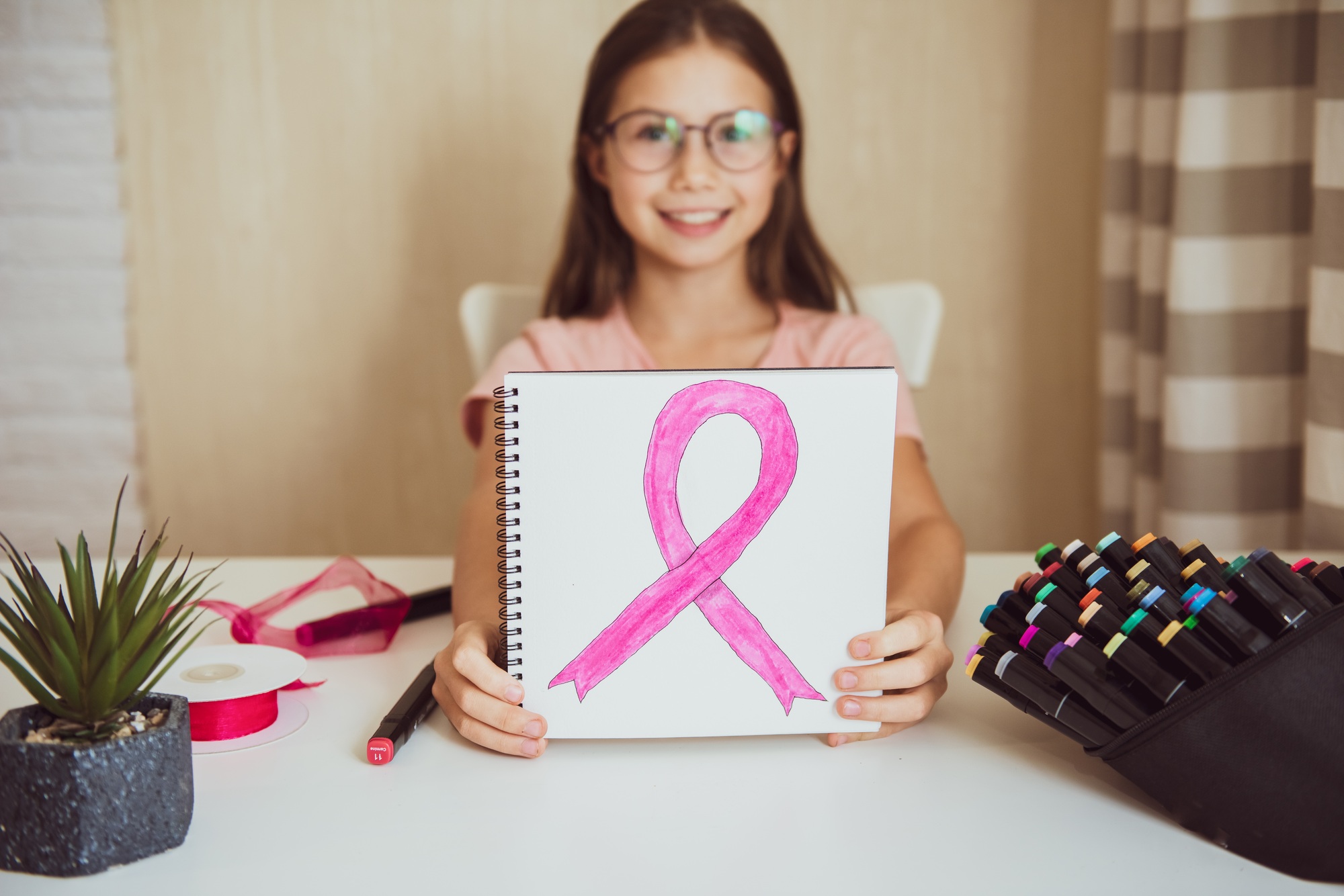 Child girl holding pink ribbon poster. Breast cancer awareness. Health care poster. Support