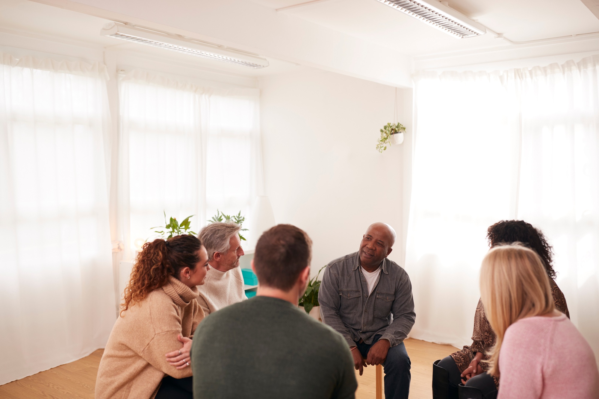 People Attending Support Group Meeting For Mental Health Or Dependency Issues In Community Space