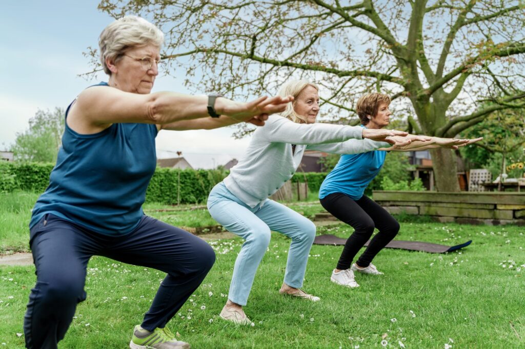 Senior Women fitness class Exercising Outdoors - Health and Wellness